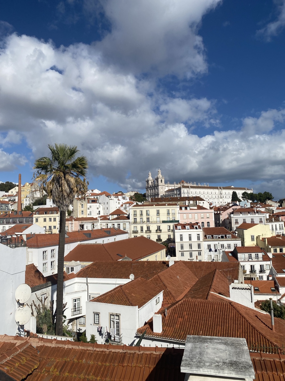 Lisbon rooftops beneath a blue sky